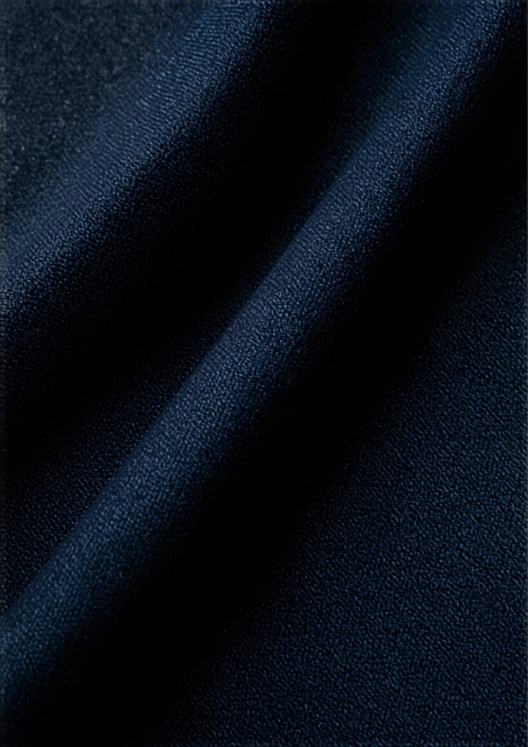 Premium Japanese selvedge raw denim indigo fabric texture close-up illustrating denim shrinkage
